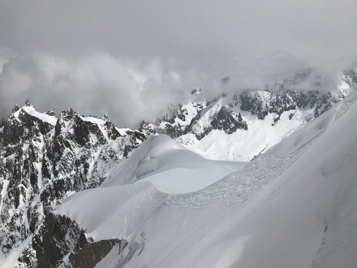 Rocky snowy mountain with unclear skies