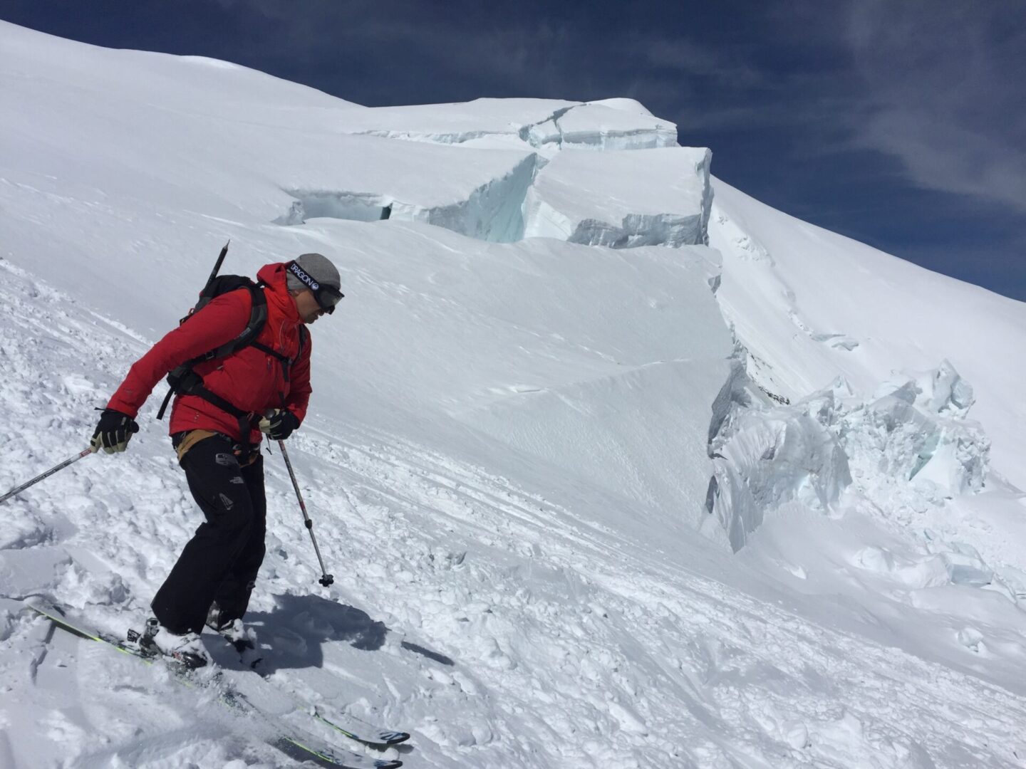 Hiker descending a snowy mountain