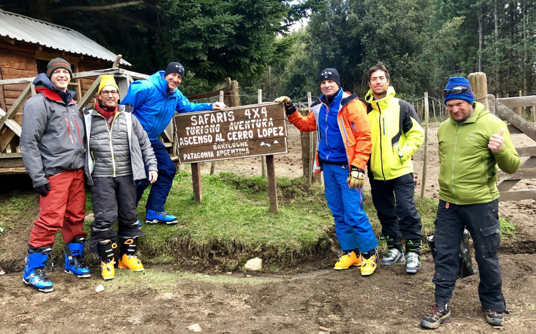 Hikers posing with a tourist site sign