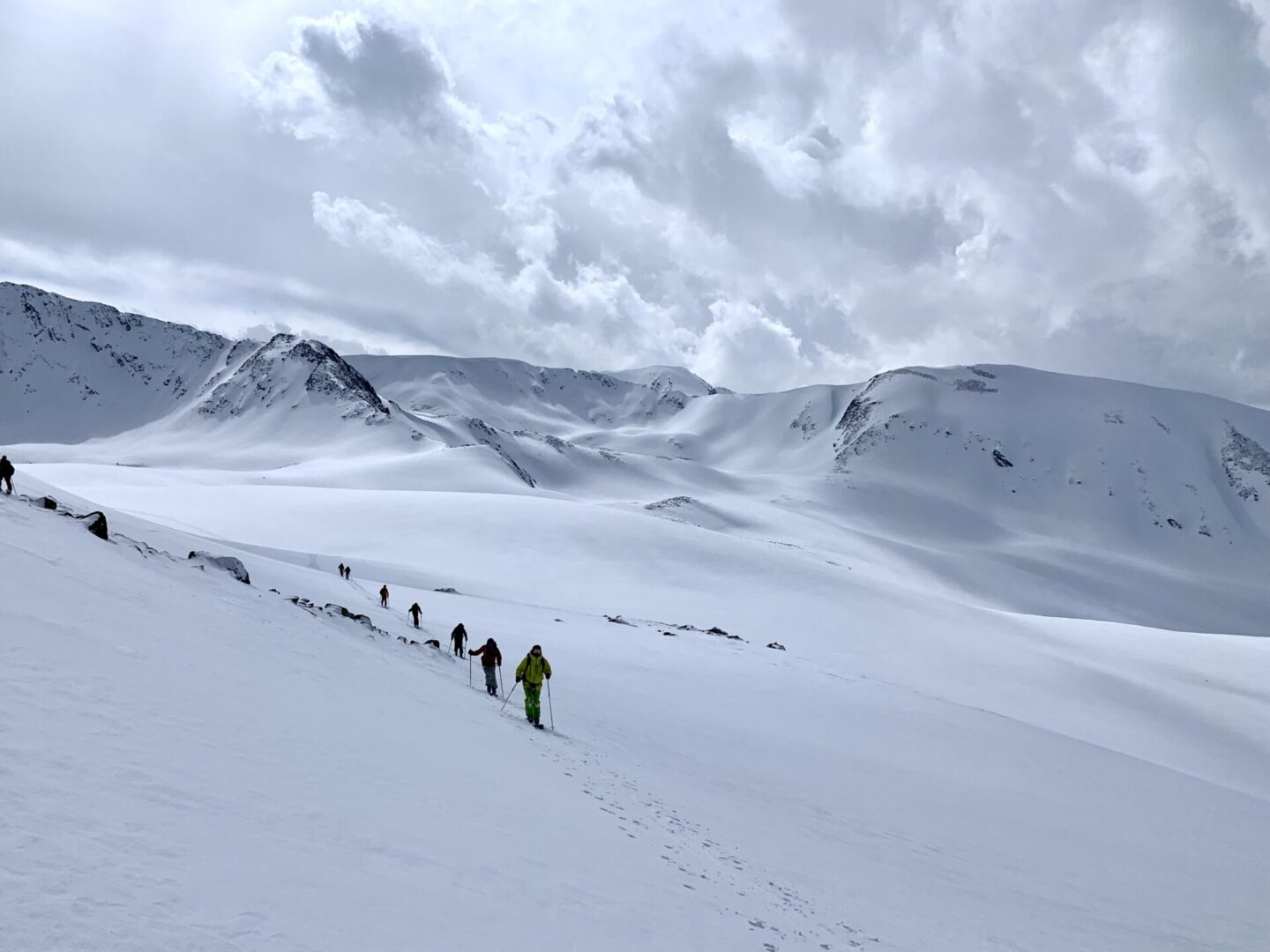 A group of people hiking on a snowy mountain